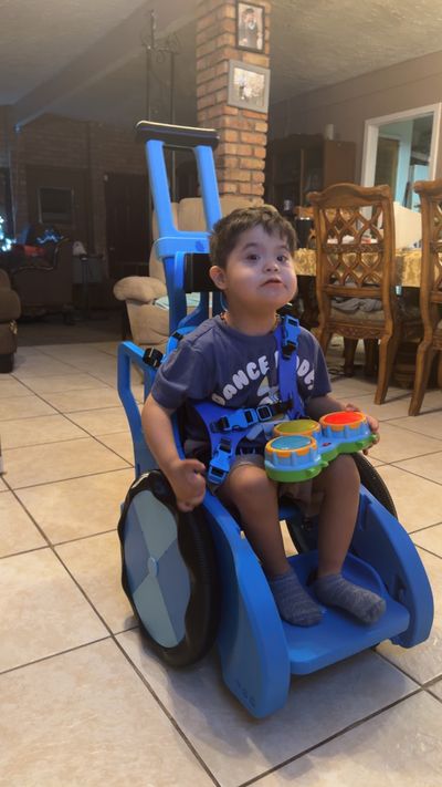 Boy uses blue Toddler Mobility Trainer